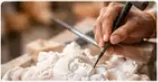 Skilled artisan hand carving a marble moorti